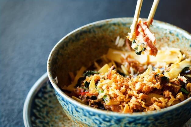 A close-up shot of a steaming bowl of Kimchi Fried Rice, topped with a perfectly cooked fried egg and garnished with sesame seeds and chopped green onions. The vibrant red color of the kimchi contrasts with the white rice and the golden yolk of the egg, creating a visually appealing and appetizing image.