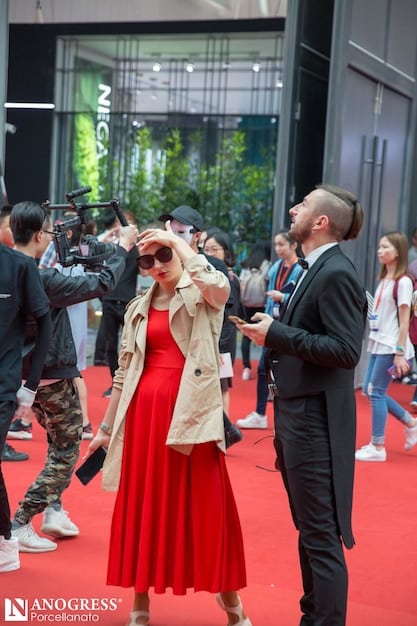 Paparazzi taking pictures of celebrities at a red carpet event, conveying the intense media scrutiny and excitement surrounding such happenings.