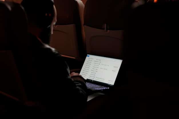 A close-up shot of a person's hands typing on a laptop keyboard, with a blurred theatre stage or movie screen in the background, symbolizing the digital creation of drama reviews.