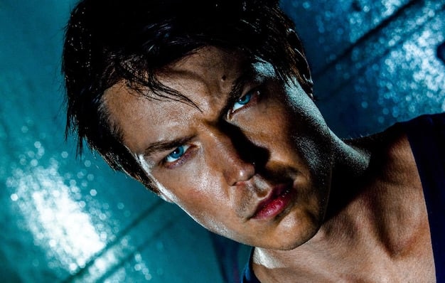 A close-up, dramatic portrait of a young male K-drama actor with intense, expressive eyes, bathed in soft, moody lighting, conveying a sense of emotional depth and determination, suitable for a rising star profile.