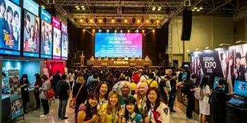 Attendees enjoying a bustling US dorama convention in 2026, featuring cosplayers and fan interactions.